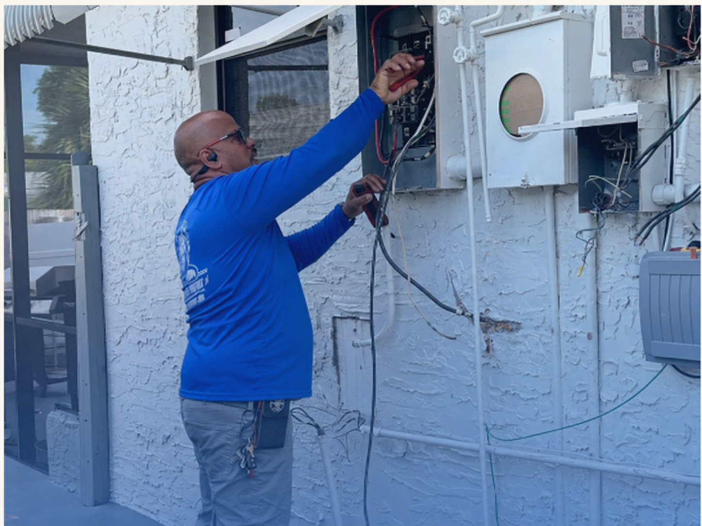 Florida Power Comfort electrician working on an electrical panel