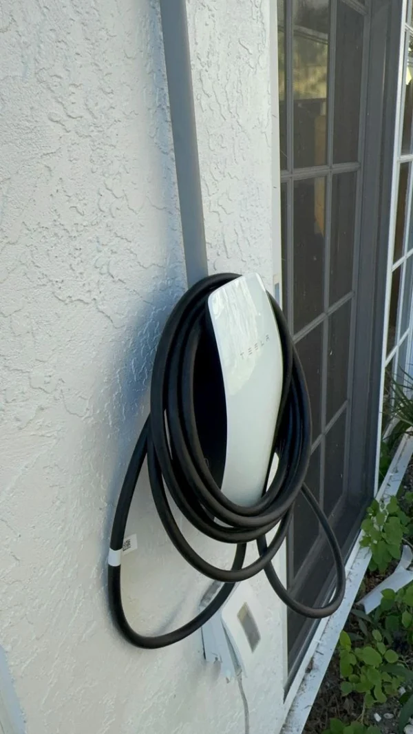 Tesla EV charger installed on a home exterior
