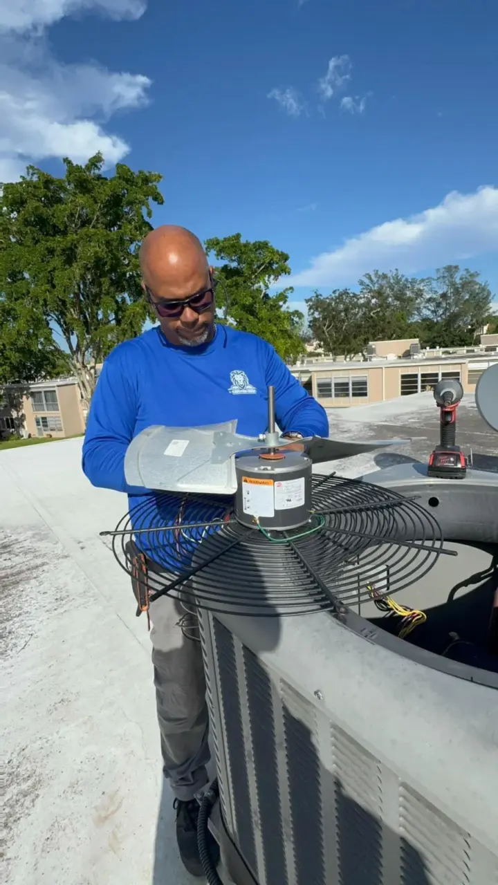Max from Florida Power Comfort replacing a condenser fan motor on a rooftop AC unit