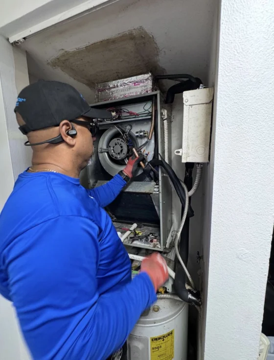 Technician repairing a wall-mounted ductless mini-split unit