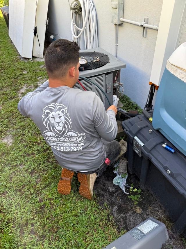 Technician servicing an outdoor condenser