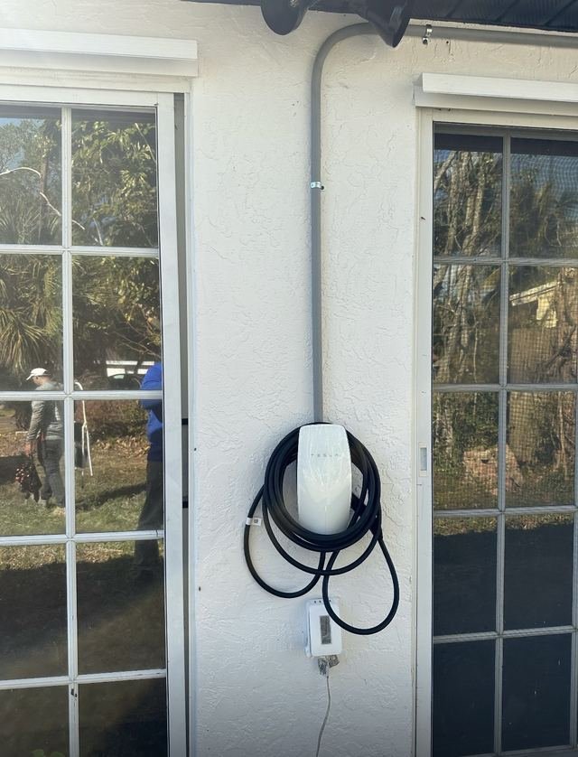 Tesla EV charger installed between exterior doors