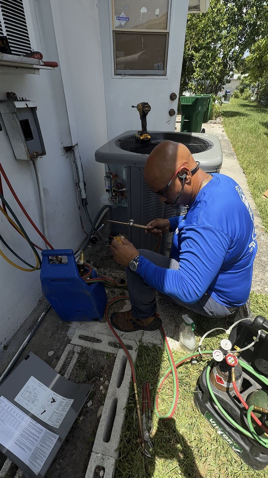 Technician working on an indoor air handler and water heater closet