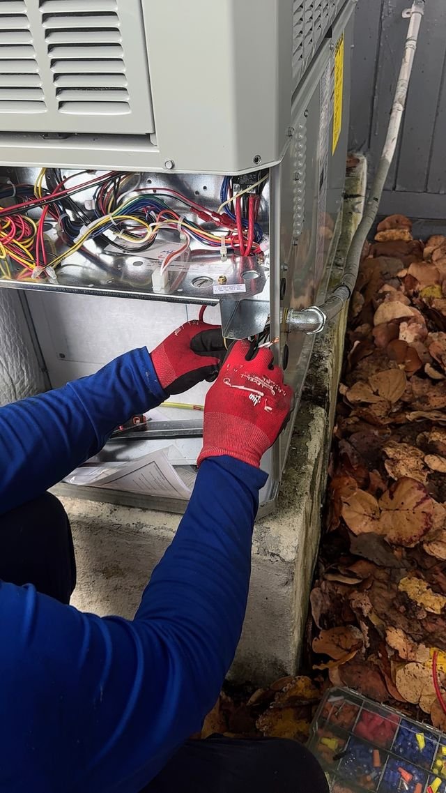 Technician wiring an air handler electrical connection