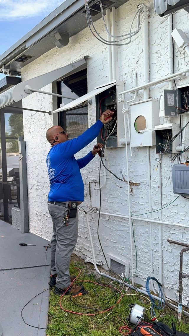 Technician working on an exterior electrical disconnect panel