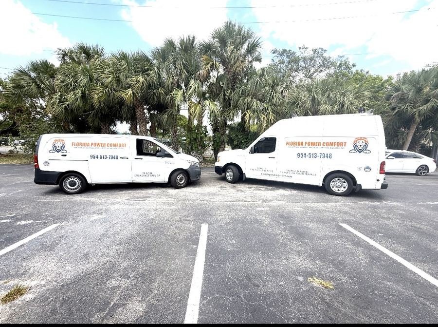 Two Florida Power Comfort service vans parked at a job site